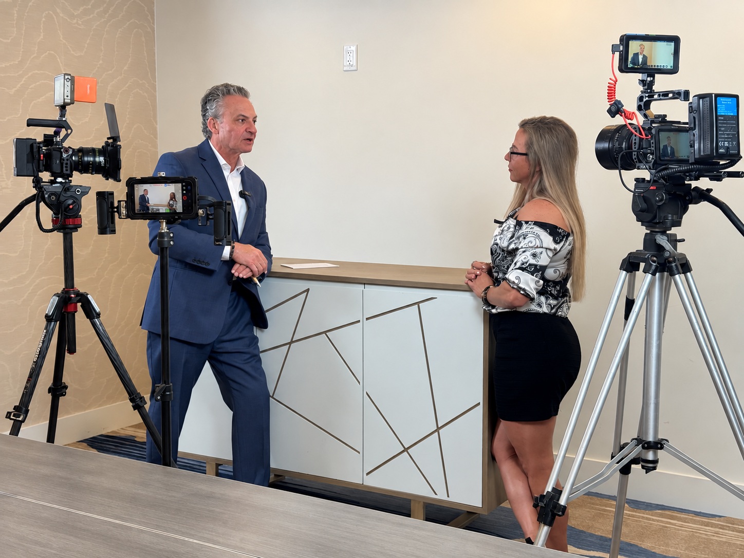 Professional on-stage interview being filmed with cinema cameras